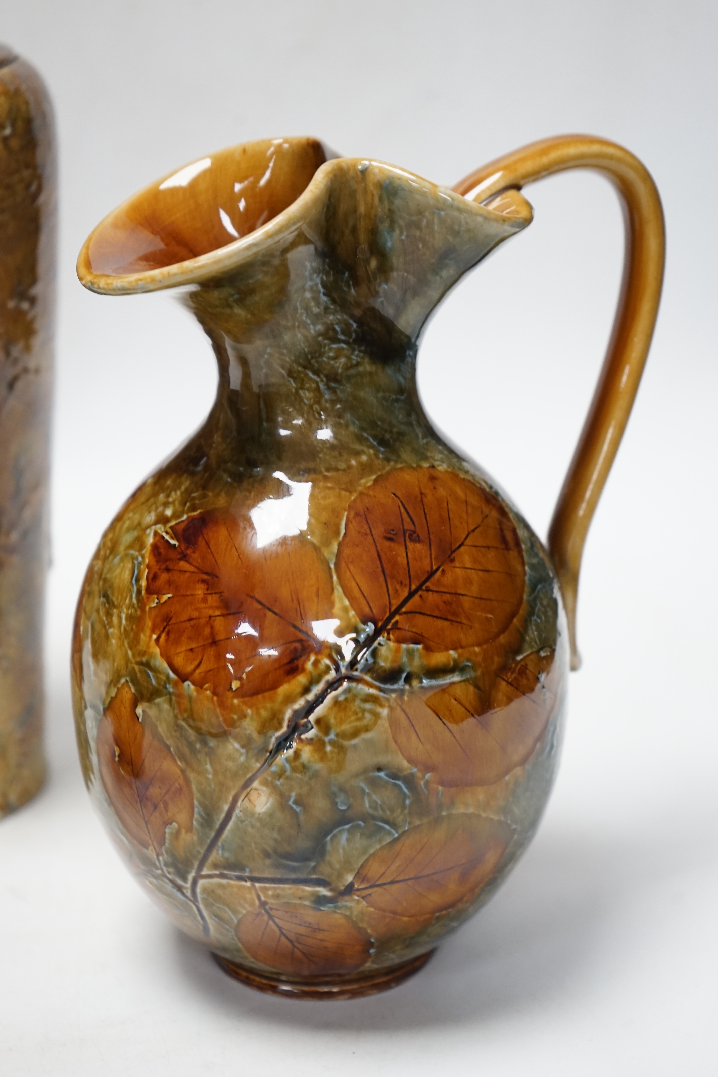 Two Doulton natural foliage ware vases and a jug, 25cm
